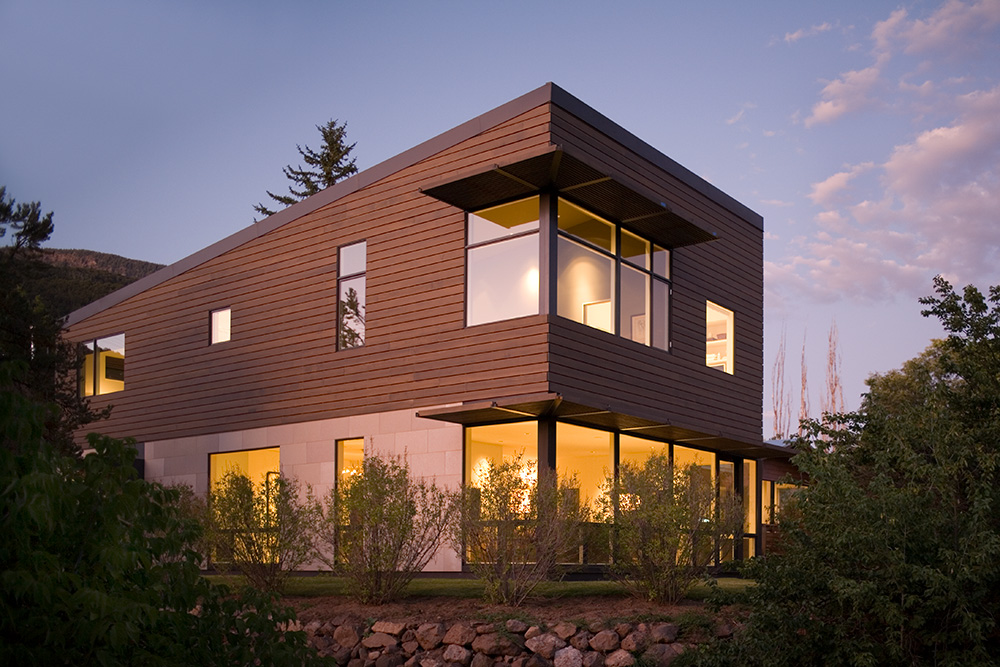 Modern home on a unique lot in Colorado, illuminated at dusk