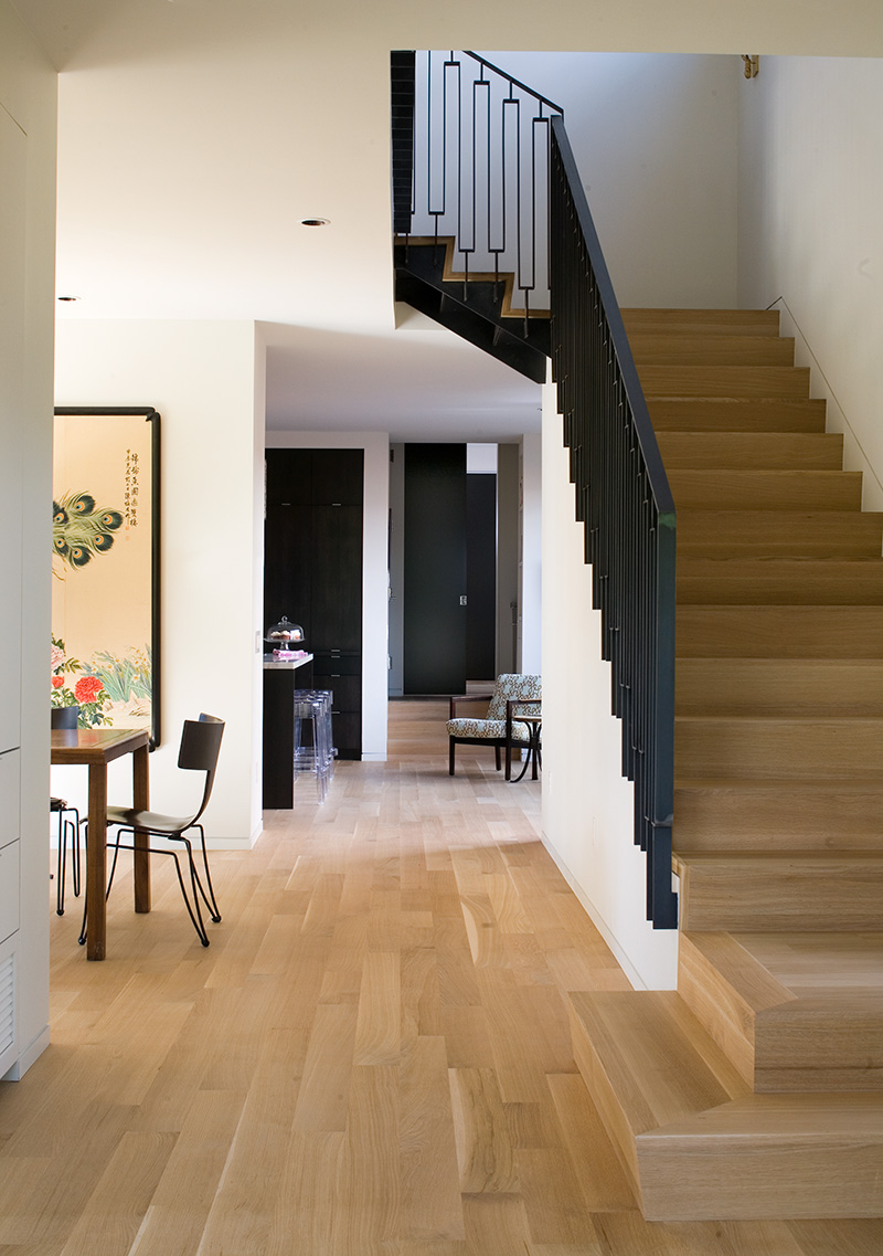 Young boy opening front door to a modern home in Colorado. Modern home on a unique lot in Colorado, illuminated at dusk Modern home on a unique lot in Colorado, illuminated at dusk Dining room and beautiful staircase with metal railing in modern Basalt home. Dining room and beautiful staircase with metal railing in modern Basalt home