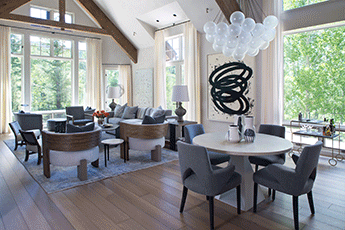 Elegant open-plan dining area featuring a large wooden table and designer chairs